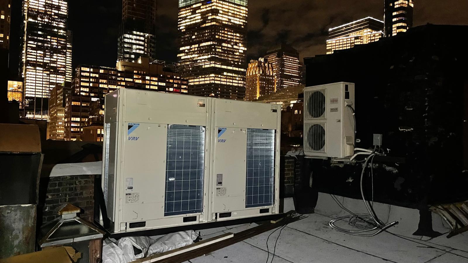 Technician inspecting the blower and coil of an air conditioning unit