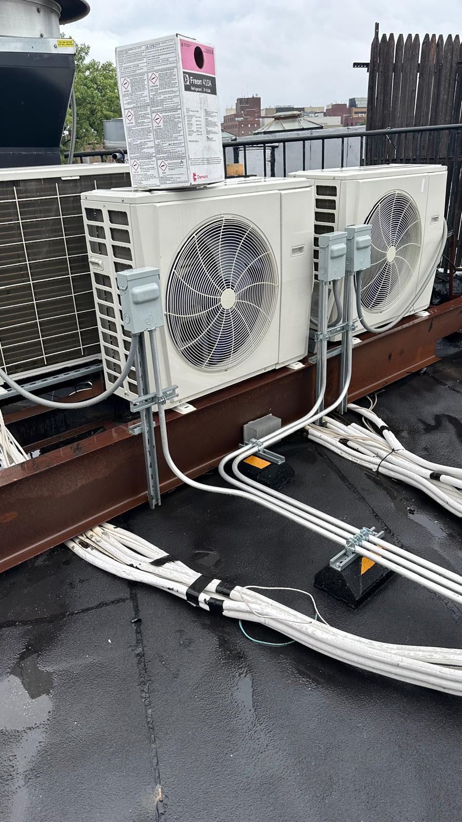 Technician assessing a building's layout and windows to size HVAC equipment