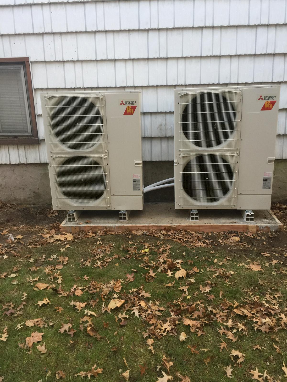 HVAC technician diagnosing a rooftop air conditioning unit on a New York City building