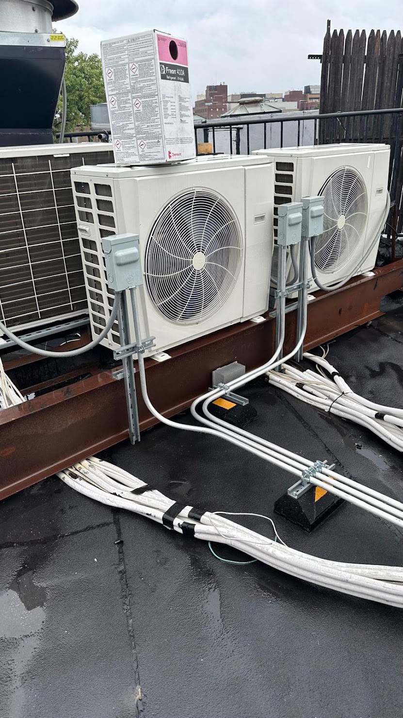 New condensing unit being installed on a New York City rooftop